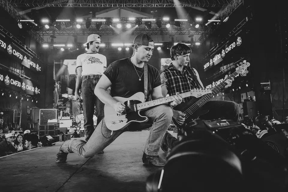Black and white shot of the full band on stage at Cowboys 2026